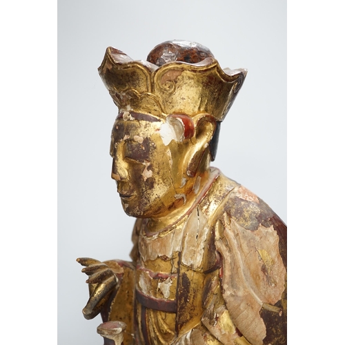 1282 - A Chinese gilt lacquered wooden figure of Buddha, possibly Yuan to Ming, 42cm high. Condition - poor... 