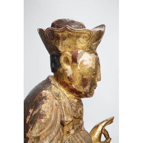 1282 - A Chinese gilt lacquered wooden figure of Buddha, possibly Yuan to Ming, 42cm high. Condition - poor... 