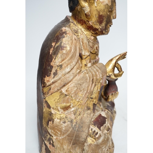 1282 - A Chinese gilt lacquered wooden figure of Buddha, possibly Yuan to Ming, 42cm high. Condition - poor... 