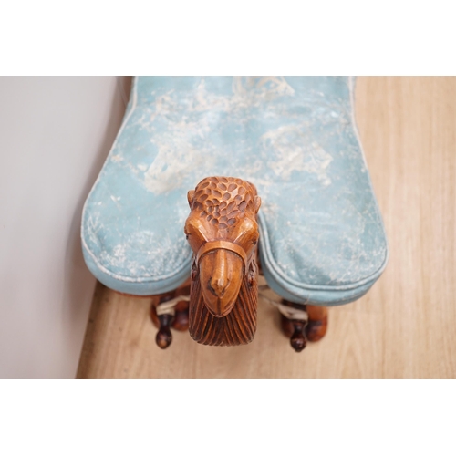 1287 - A carved wood foot stool in the form of a camel, blue stamped patterned leather cushion, 56cm high, ... 