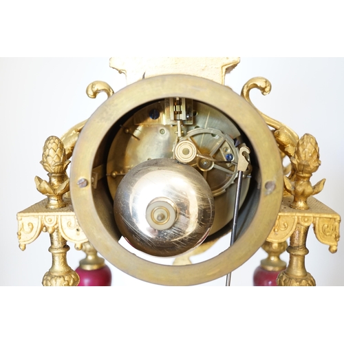 1396 - A late 19th century gilt metal and porcelain mounted mantel clock with associated stand, key and pen... 