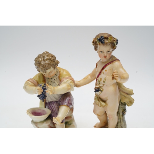 1412 - Two Meissen porcelain figures, boys with grapes, largest 13cm high. Condition - poor