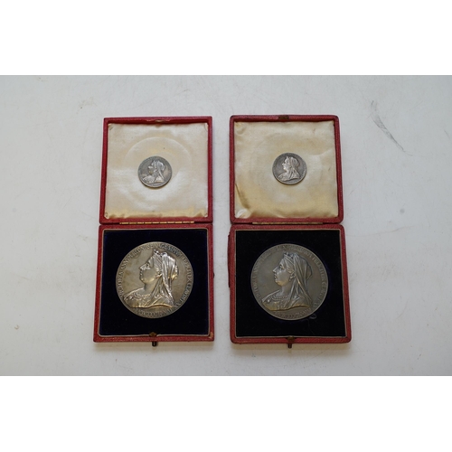 1419 - Two Victoria 1897 Diamond Jubilee commemorative silver medals, cased, and two smaller silver medals.... 