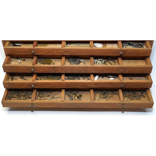 1436 - A wooden twelve drawer cabinet containing a collection of watch parts. Condition - cabinet fair to g... 