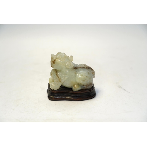 1445 - A Chinese carved jade lion dog and stand, 8cm tall. Condition fair to good.