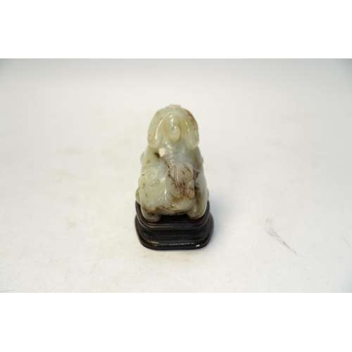 1445 - A Chinese carved jade lion dog and stand, 8cm tall. Condition fair to good.