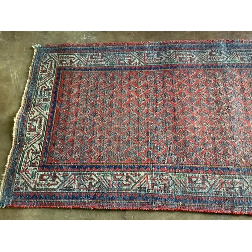 11 - A pair of North West Persian brick red ground rugs, each 124 x 79cm. Condition - fair