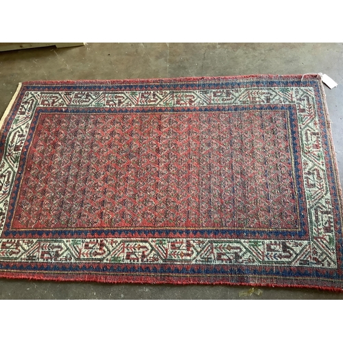 11 - A pair of North West Persian brick red ground rugs, each 124 x 79cm. Condition - fair