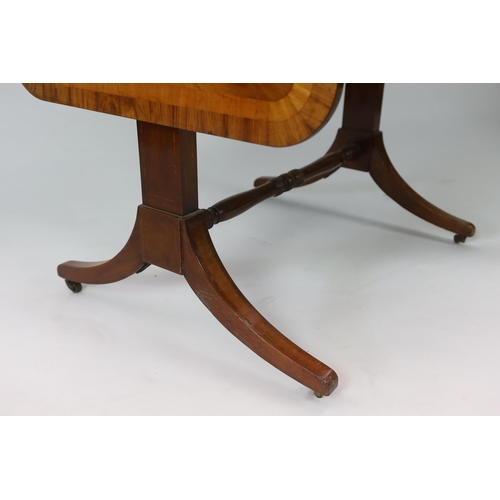 142 - A Regency satinwood banded mahogany sofa table, with two frieze drawers on end standards with turned... 