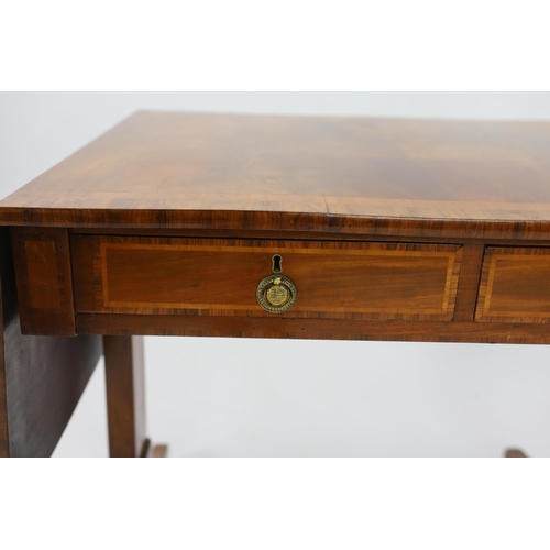 142 - A Regency satinwood banded mahogany sofa table, with two frieze drawers on end standards with turned... 