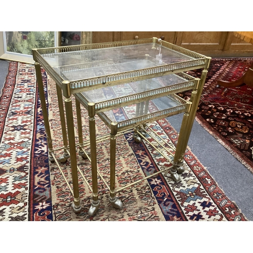 147 - A nest of three mid century brass and glass tea tables, width 52cm, depth 32cm, height 52cm.  Condit... 