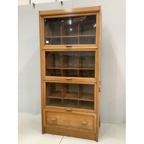 16 - A mid century glazed oak haberdasher's cabinet, width 92cm, depth 50cm, height 198cm. Condition - fa... 