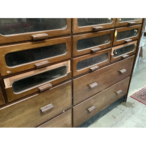 18 - A large mid century mahogany haberdasher's cabinet, width 183cm, depth 50cm, height 199cm. Condition... 