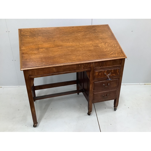 27 - An Arts & Crafts metamorphic oak patent kneehole architect's desk, fitted three small side drawers, ... 