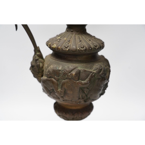 322 - A Cellini style bronze ewer, possibly converted to a lamp later, decorated with putti panel and head... 