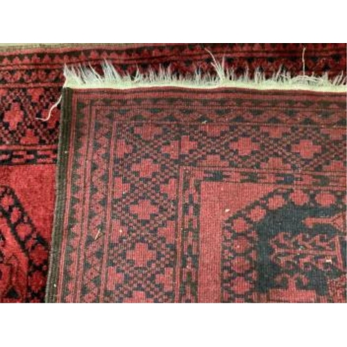 38 - Two Afghan red ground rugs, largest 170 x 120cm. Condition - fair