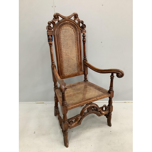 40 - A William and Mary walnut and beech armchair, with a patera carved crest rail, and square and scroll... 