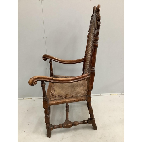 40 - A William and Mary walnut and beech armchair, with a patera carved crest rail, and square and scroll... 