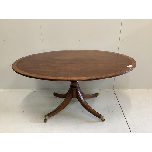 49 - A George III and later satinwood banded oval mahogany tilt top dining table, width 152cm, depth 103c... 