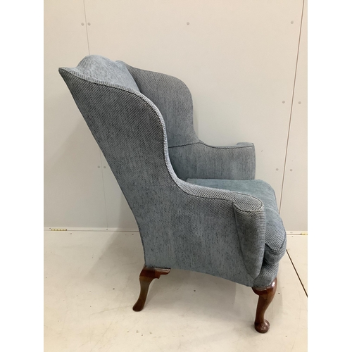 56 - A George I walnut wing armchair, upholstered in blue fabric. Condition - good
