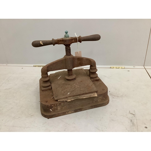 64 - A Victorian cast iron book press, height 30cm. Condition - poor