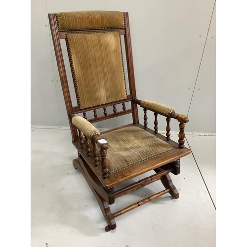 82 - A late 19th century American oak and beech upholstered rocking chair, width 58cm, depth 54cm, height... 