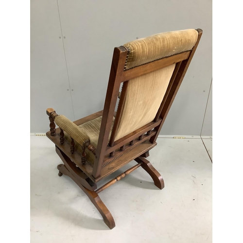 82 - A late 19th century American oak and beech upholstered rocking chair, width 58cm, depth 54cm, height... 