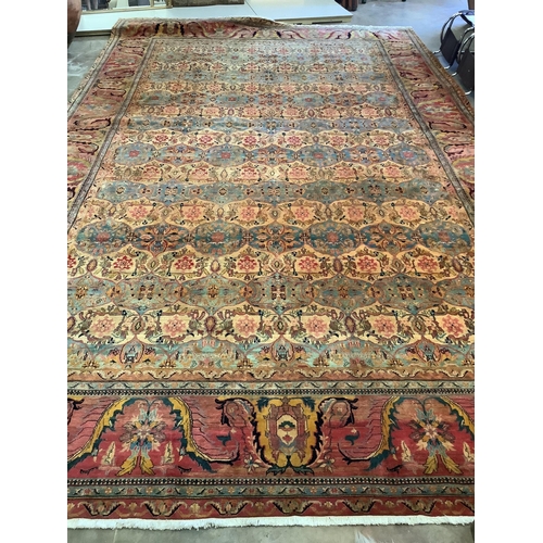 88 - A large Persian design ivory ground carpet, 590 x 365cm. Condition - good