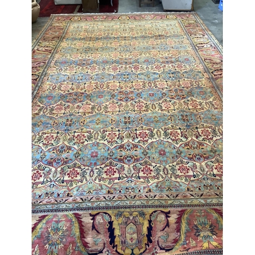 88 - A large Persian design ivory ground carpet, 590 x 365cm. Condition - good