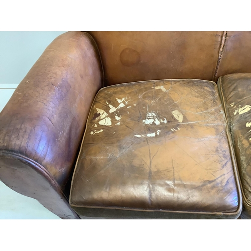 1016 - A French leather moustache back sofa, width 148cm, depth 80cm, height 80cm. Condition - poor