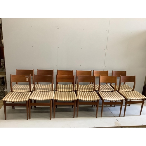 1023 - A mid century Gordon Russell teak dining suite comprising rectangular extending table, twelve chairs... 