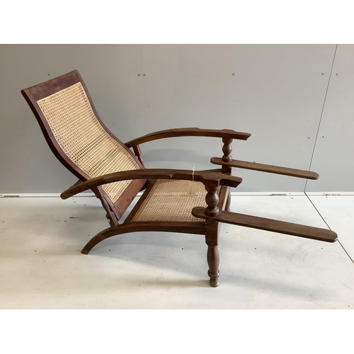 1041 - A caned hardwood plantation chair, width 63cm, depth 93cm, height 94cm. Condition - fair