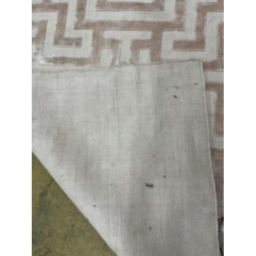 1066 - A Contemporary geometric pink ground carpet, 300 x 200cm. Condition - fair