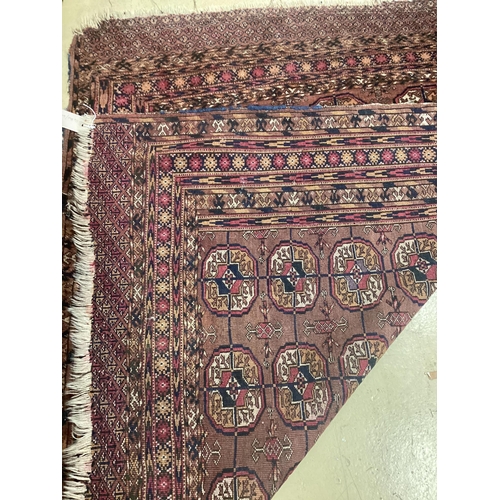 1083 - A Tekke plum ground rug, 130 x 110cm. Condition - fair