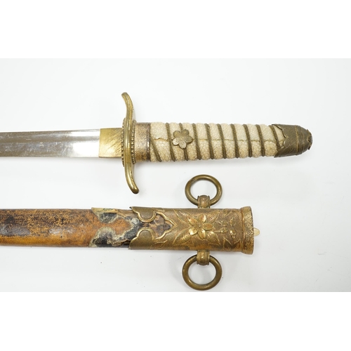 1377 - A dagger with brass fittings and a shagreen grip, in a leather covered scabbard, blade 21cm. Conditi... 