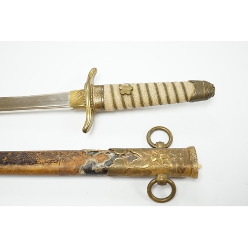 1377 - A dagger with brass fittings and a shagreen grip, in a leather covered scabbard, blade 21cm. Conditi... 