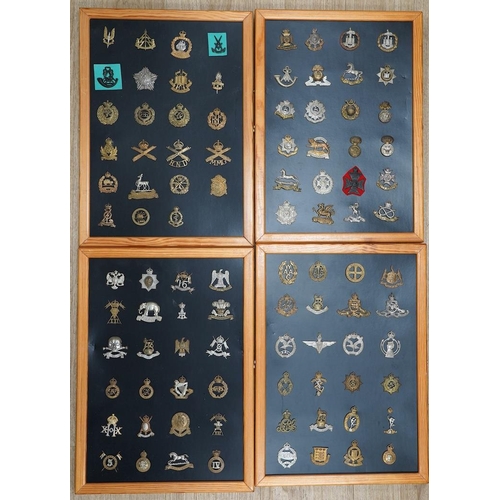 1384 - A collection of ninety-five military cap badges mounted on four boards including; The Reconnaissance... 