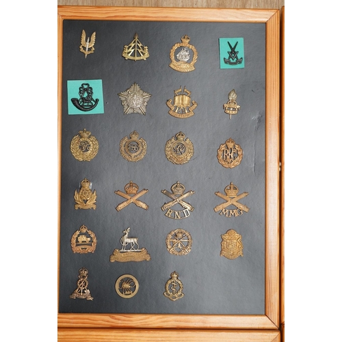 1384 - A collection of ninety-five military cap badges mounted on four boards including; The Reconnaissance... 