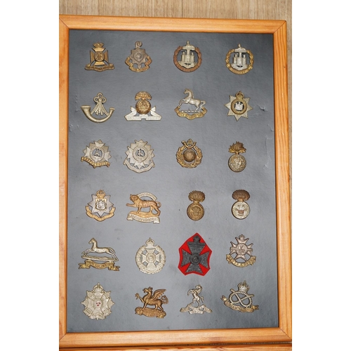 1384 - A collection of ninety-five military cap badges mounted on four boards including; The Reconnaissance... 