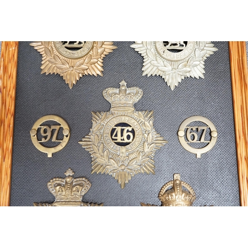 1386 - Five military helmet plates and two other centre badges mounted on a board, including; the Royal Lan... 