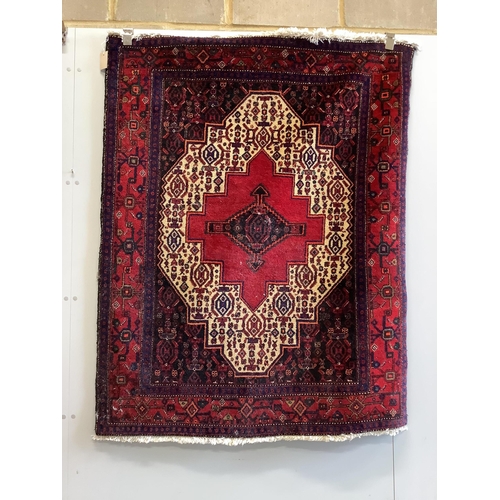 11 - A Shiraz red ground rug, 150 x 120cm. Condition - fair