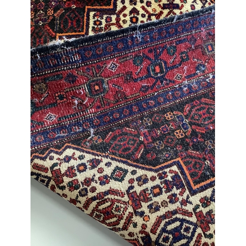 11 - A Shiraz red ground rug, 150 x 120cm. Condition - fair