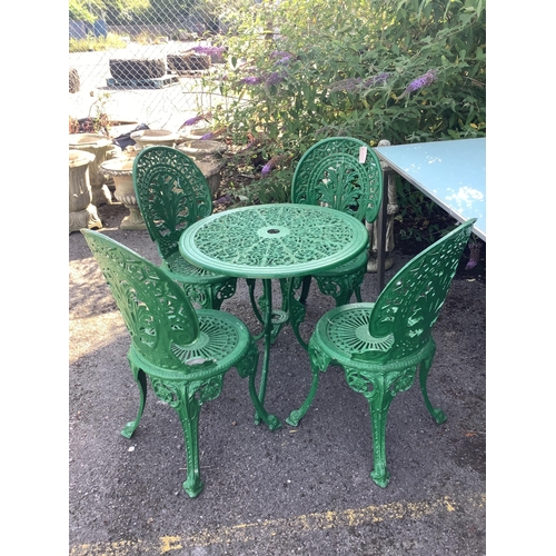 1010 - A Victorian style painted aluminium circular garden table, diameter 68cm, height 65cm and four chair... 