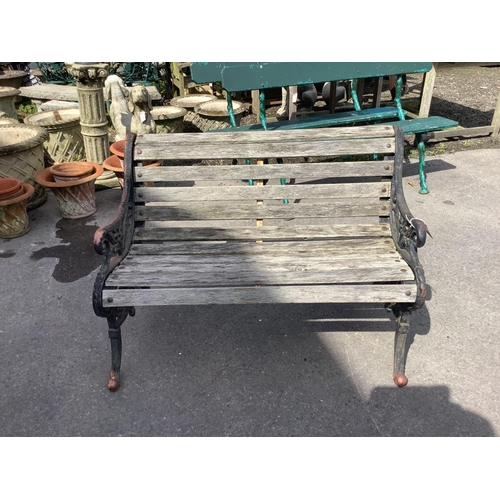 1015 - A Victorian style wrought iron slatted garden bench, width 122cm, height 82cm. Condition - fair... 