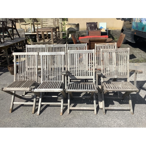 1016 - A set of eight (six plus two) weathered teak folding garden chairs, two with arms. Condition - good... 