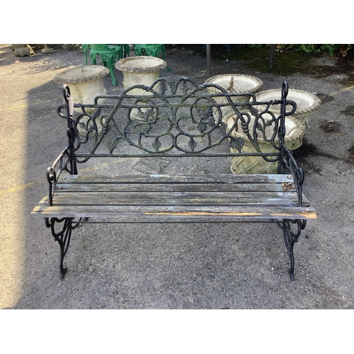 1019 - A Victorian style cast iron slatted garden bench, width 106cm, height 76cm. Condition - poor