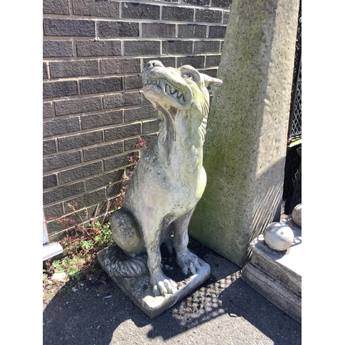 1030 - A reconstituted stone gargoyle garden ornament, height 100cm. Condition - fair