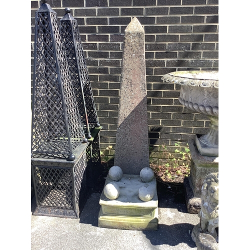 1032 - A pair of reconstituted stone obelisk garden ornaments on stands, height 180cm. Condition - fair... 