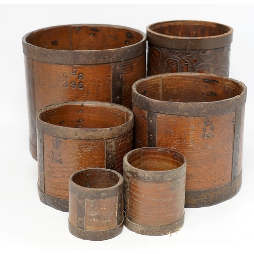 1266 - A matched set of five early 20th century iron bound bushel measures, one peck to half pint, together... 