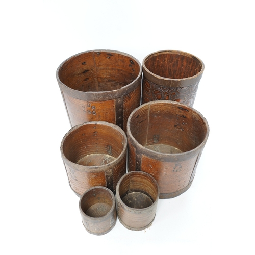 1266 - A matched set of five early 20th century iron bound bushel measures, one peck to half pint, together... 